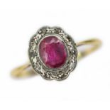 An antique ruby and diamond ring, the oval cluster measuring approx. 10mm x 9mm, band marked 'PT