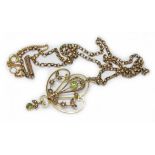 An antique peridot and seed pearl pendant, length 48mm, on 44cm chain, both marked '9c', gross wt.