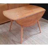 An Ercol light elm drop leaf table, model 384, designed in 1956 by Lucian Ercolani, height 72cm,