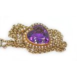 An antique amethyst and seed pearl heart shaped pendant marked '15ct', length including bale 37mm,
