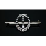 An Art Deco diamond brooch, the millegrain set wreath of diamonds measuring approx. 17mm x 22mm,