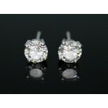 A pair of diamond stud earrings, each round brilliant cut stone weighing approx. 0.62cts each,