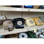 Four vintage twist dial telephones, one wall mounted, the other table phones.