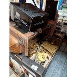 A box of clock parts together with a wall clock and a cuckoo clock.