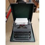 A vintage Olympia typewriter in case.