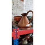 A copper pitcher and a copper planter.