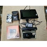 Three vintage cameras comprising an Olympus A11, Practika, Fujifilm and a digital photograph frame.