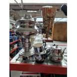 A five piece tea urn set.