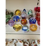 12 glass paperweights including Isle of Wight Glass, Caithness etc.