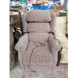 A grey upholstered electric reclining armchair.