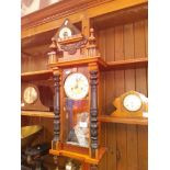 A Vienna wall clock with pendulum and key together with an early 20th century barometer.