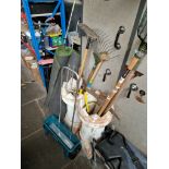 A quantity of garden tools, pick axe, lawn spreader and two pies of artificial turf