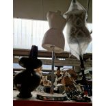 A dressmakers dummy and two anglepoise lamps