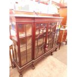 A 1920s astragal glazed mahogany bookcase with gallery rail, gadrooned edge, claw and ball feet.