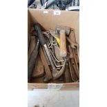 A mixed lot of hand tools including pick axe, sledge hammer, large metal bar, hammers, chisels, etc.