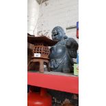 An Eastern cast iron candle holder and a Buddha.