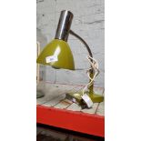 A mustard colour anglepoise lamp.