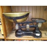 A cast metal weighing scales with bras tray and weights.