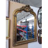 An ornate gilt framed mirror.