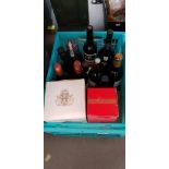 A box of alcoholic beverages to includde VSOP brandy, a sealed Bell's decanter, sherry, port and