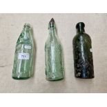 Three old glass bottles, two from Warrington (one with glass marble) and one from St Helens.