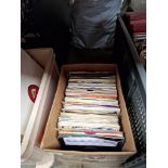 A box of 7" vinyl singles.