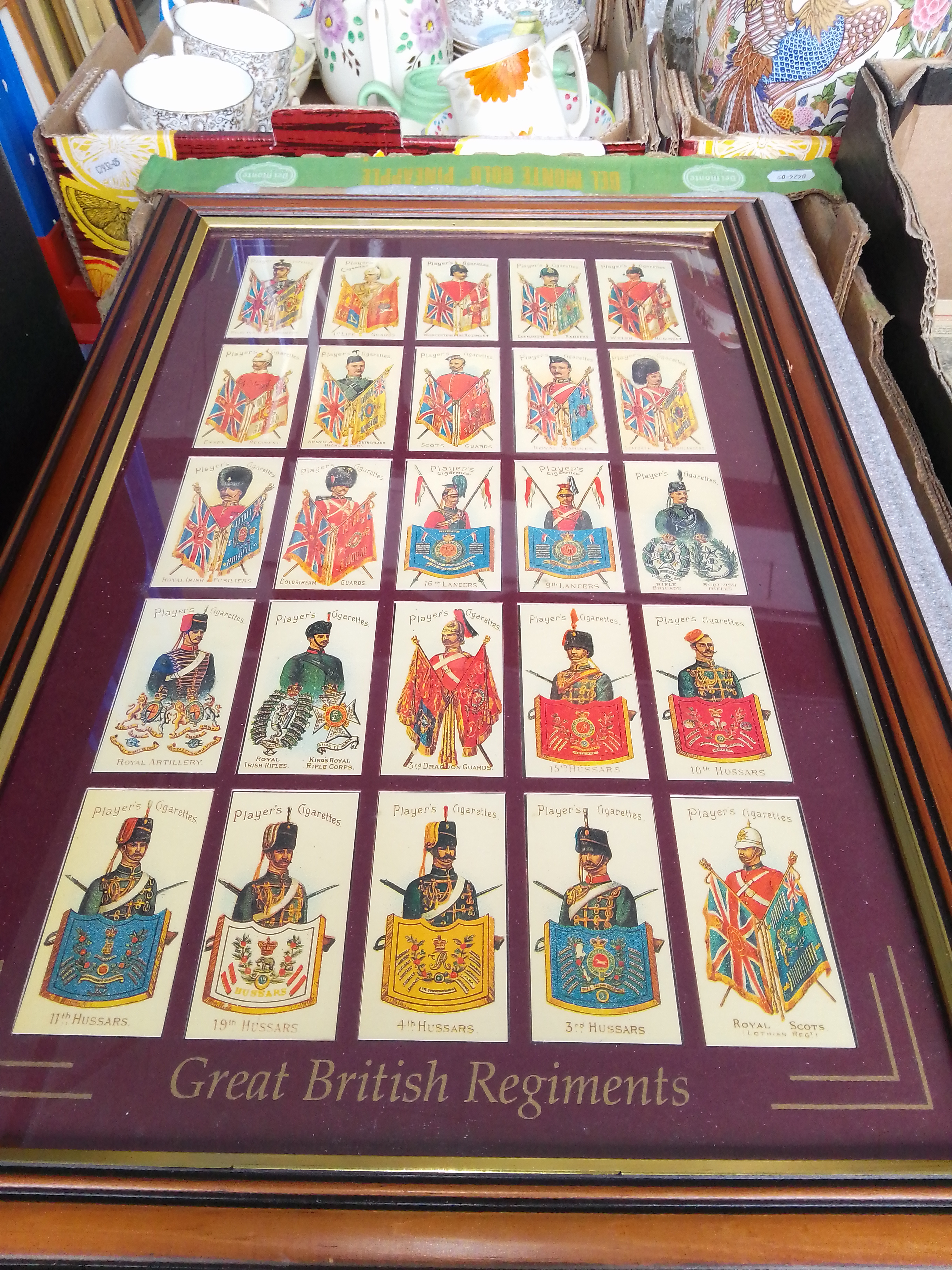 A box of framed reproduction cigarette cards.