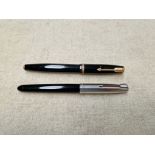 Two Parker pens, one with a 14K nib.