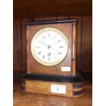 A French mantle clock with pendulum and key.