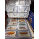 A folder of cigarette cards, full sets and some loose.