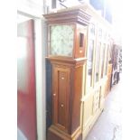 A longcase clock with enamelled dial.