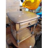 An Ercol side table with drawer.