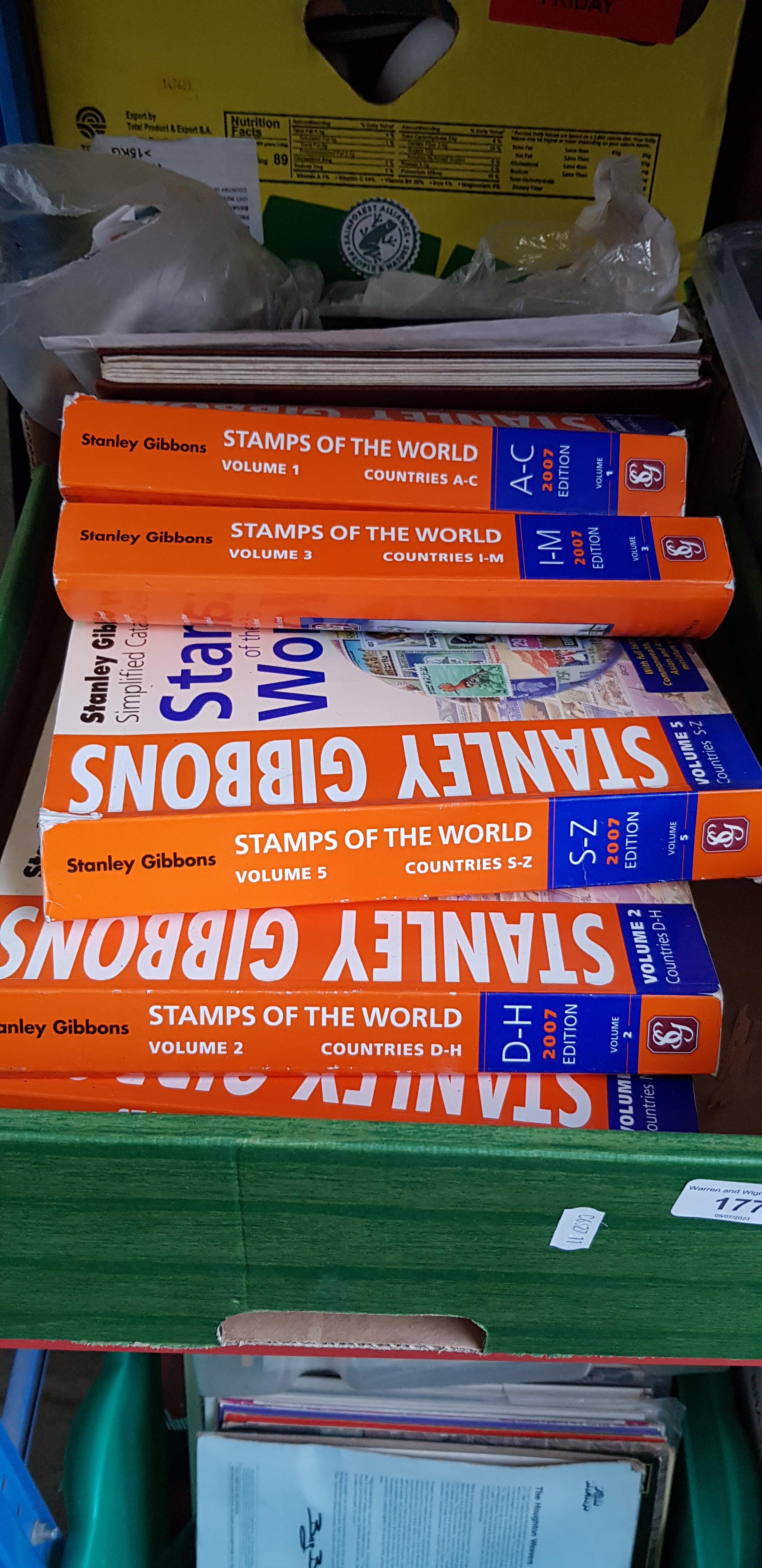 A box of stamps and stamp catalogues.