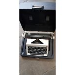 An Olympia portable typewriter, in case.