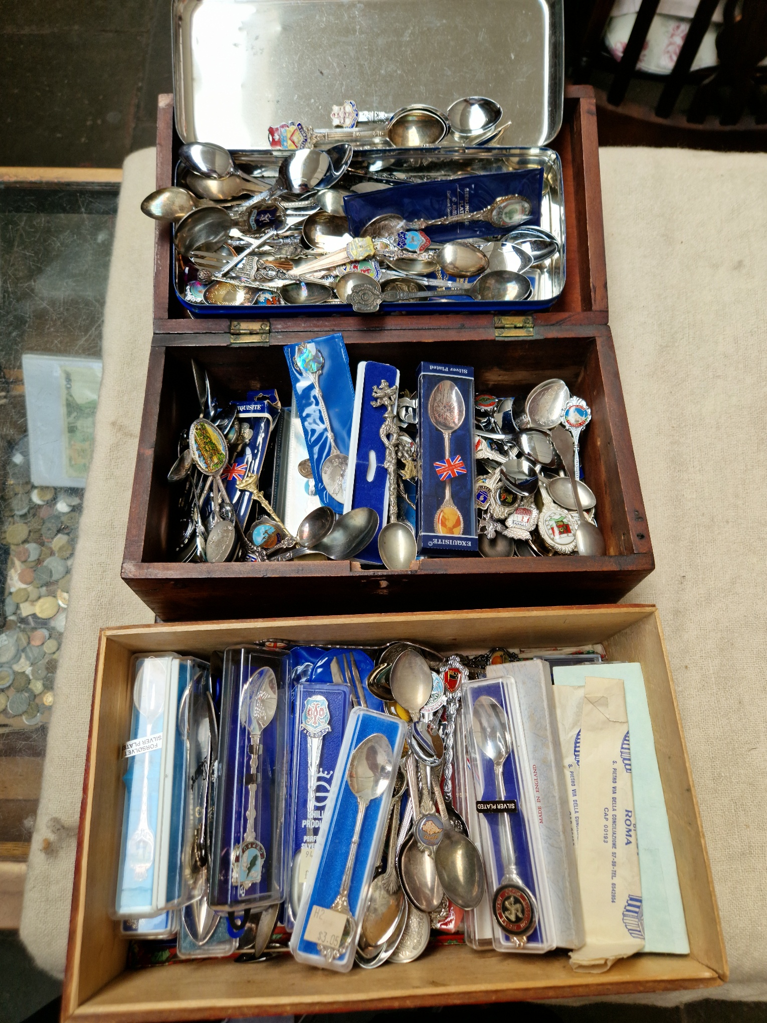 Three boxes of various collectors teaspoons, mostly travel.