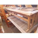 A wooden garden table and two benches.