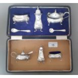 A three piece hallmarked silver cruet, together with a cased silver plated cruet.
