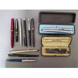 A collection of pens to include a Parker pen with 14k gold nib, etc.