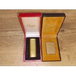 x vintage Cartier gold plated textured lighter in box & a vintage Dupont gold plated textured....