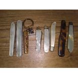 A collection of 8 penknives to include 4 silver and mother of pearl, etc.