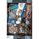 A box of mixed jewellery and collectables to include some badges, cutthroat razor, silver,