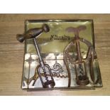 A tin of assorted corkscrews to include a Victorian James Heeley & Sons 6006 double lever, a brass