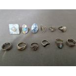 A suite of 12 silver rings, various settings and sizes.