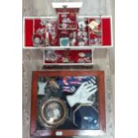 A display case containing various collectables to include jewellery, Corgi, etc together with a