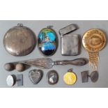 A selection of silver items including a 1920s - 1930s butterfly pendant, mirror pendant, vesta case,