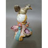 An early 19th century Staffordshire pottery inkwell modelled as an eagle perched on a globe....