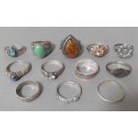 A quantity of 12 silver rings, various sizes and settings.