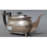 A hallmarked silver teapot of oblong cushion form with gadrooned rim, on bun feet, gross wt. 21.3