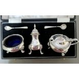 A silver cruet set with cobalt blue glass liners, in original box, Sheffield, Roberts & Belk Ltd...