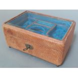 An antique jewellery box with fitted interior and bevelled glass top, with key.
